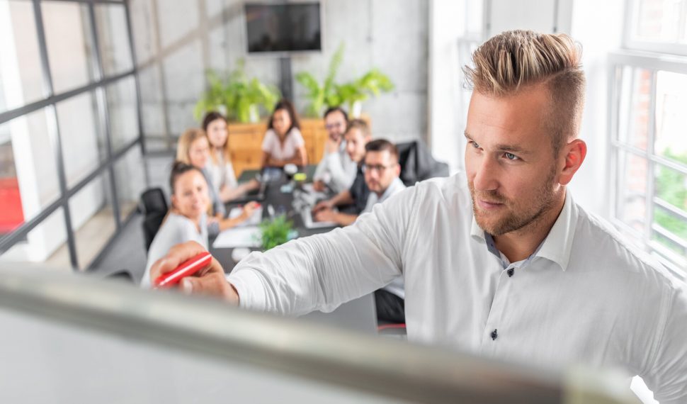 Business coach concept. Business coach. Team leader teaches employees at a business meeting in a conference room.